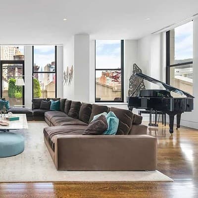 An apartment staged with elegant furniture and a grand piano
