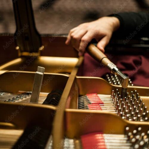 Piano tuner using a key to tension a wire inside a piano