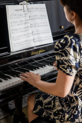 School girl playing the piano