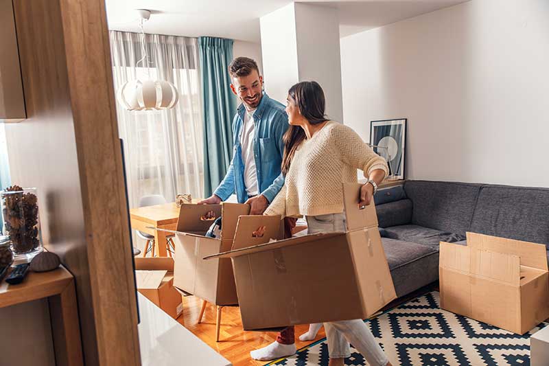 man and a woman packing boxes in an apartment in New York