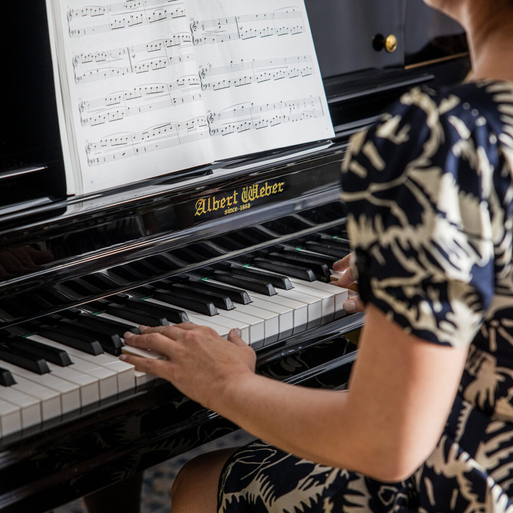 School girl playing the piano
