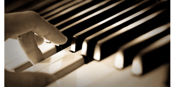 fingers hovering over a piano keyboard